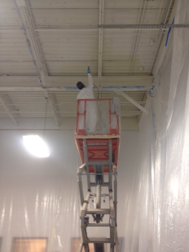 Commercial Painter in Missouri spraying a dry fall coating in a factory in MO